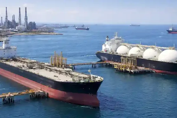 Oil tanker and LNG carrier docked at coastal terminal amid Asia oil and LNG imports supply risk