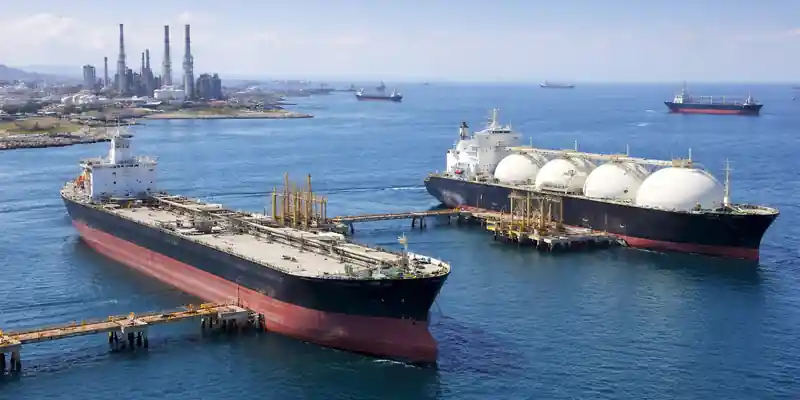 Oil tanker and LNG carrier docked at coastal terminal amid Asia oil and LNG imports supply risk