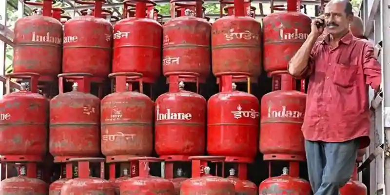 India LPG shortage with stacked domestic gas cylinders and supply pressure